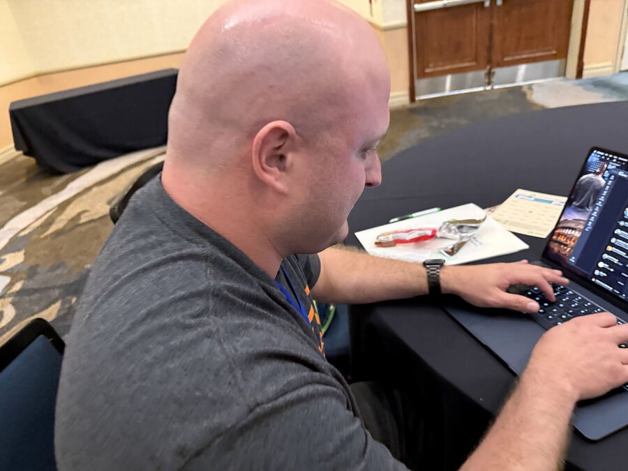 An attendee building along on his laptop