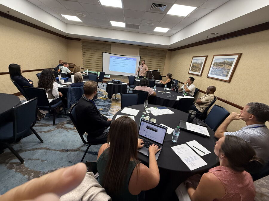 A full classroom at Black Sheep Convention 2026, laptops open